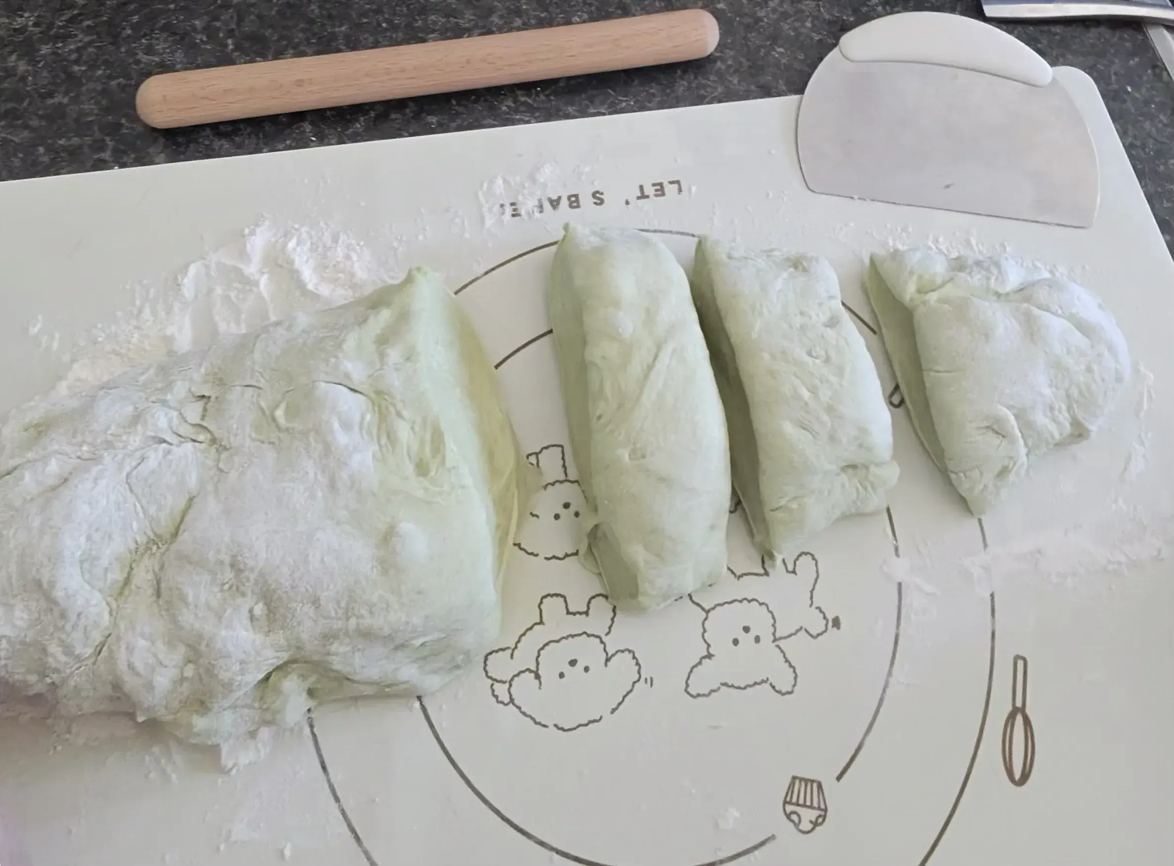 Divided dough portions on baking mat