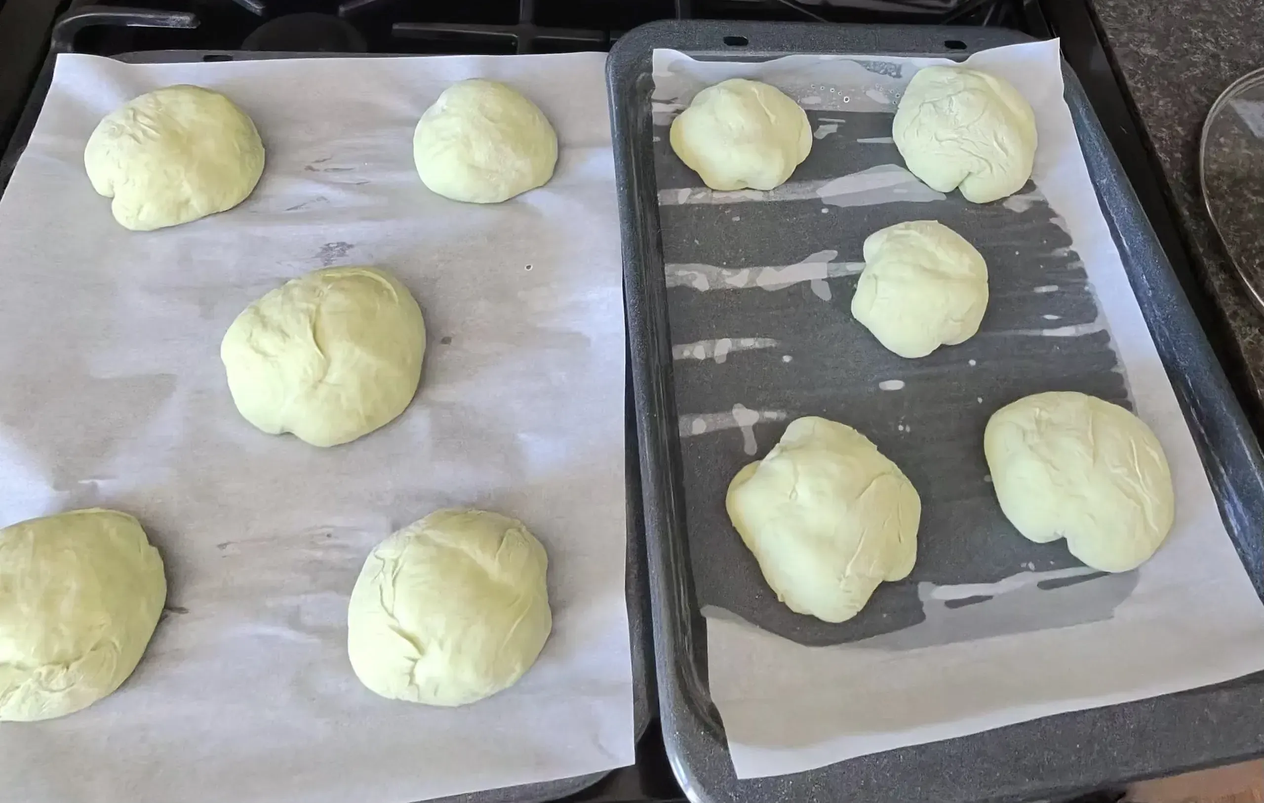 Shaped round buns proofing on baking trays